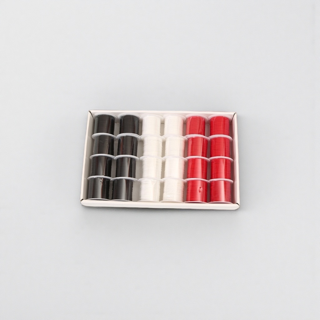 A white box contains a set of black, white and red spool winders for sewing machines