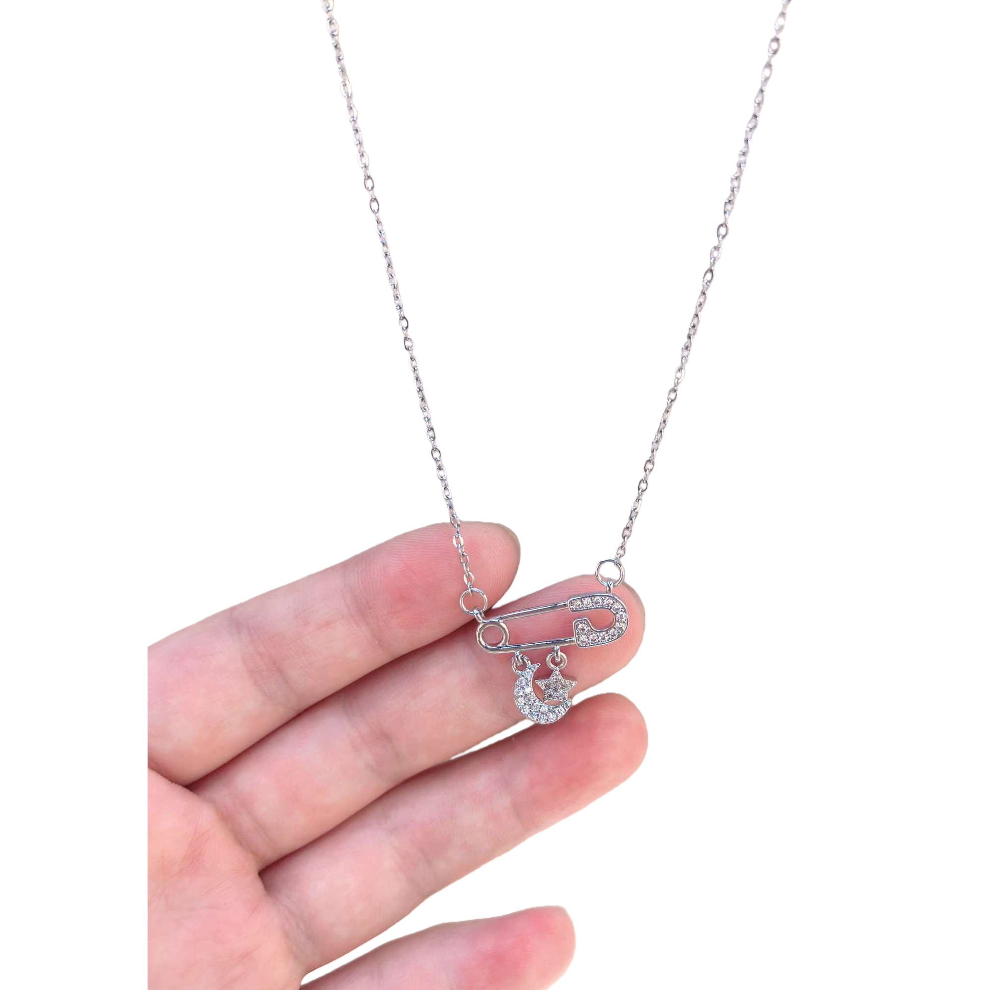 Silver safety pin necklace with diamond-encrusted moon and star pendant Specification image
