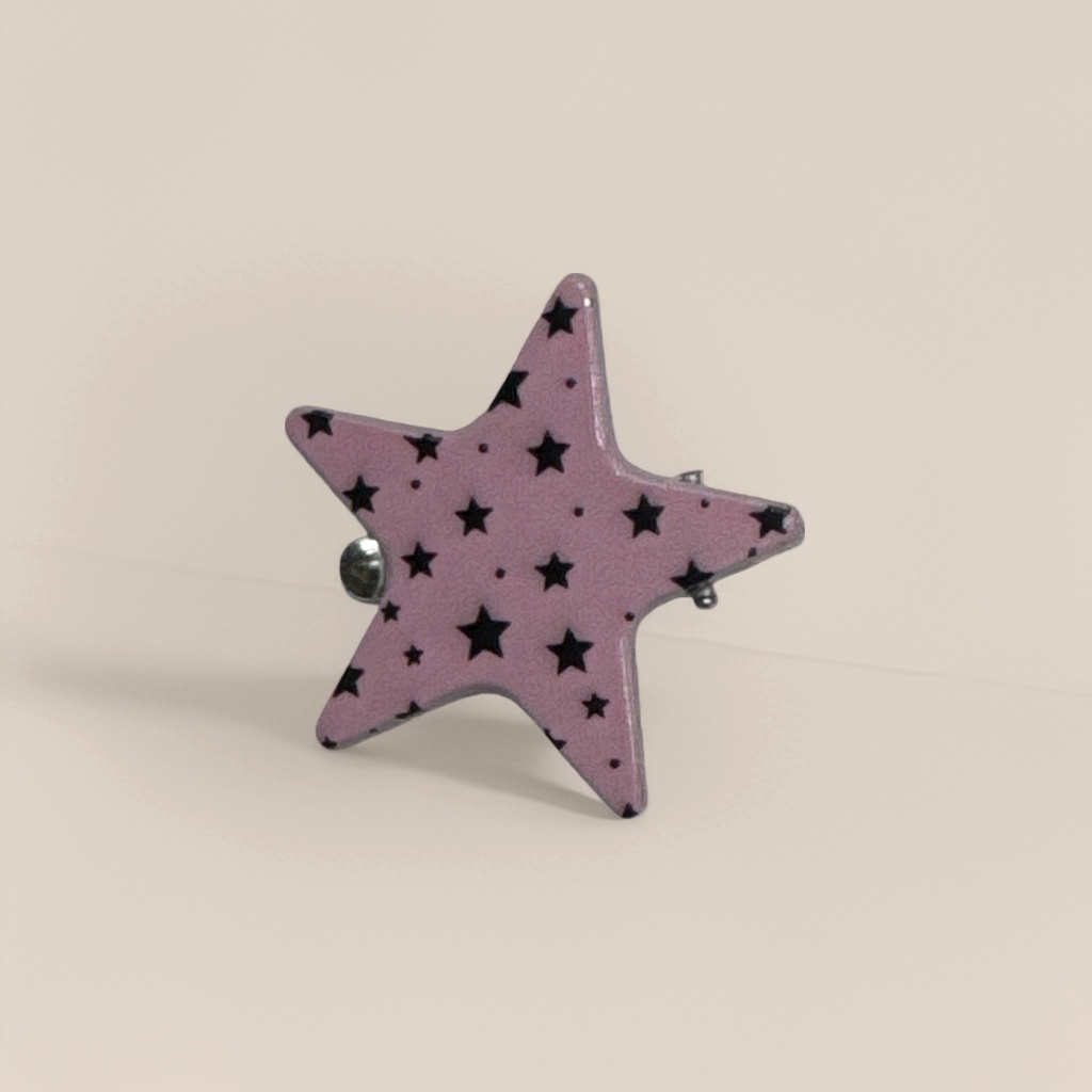 A pink star-shaped brooch is a fashionable and simple metal accessory for women's daily wear