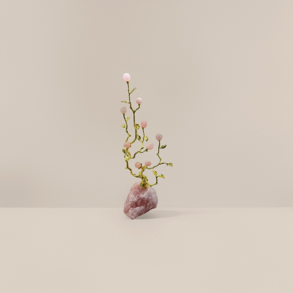 A pink gemstone ornament inlaid with golden branches and a rose quartz base Application Scenario