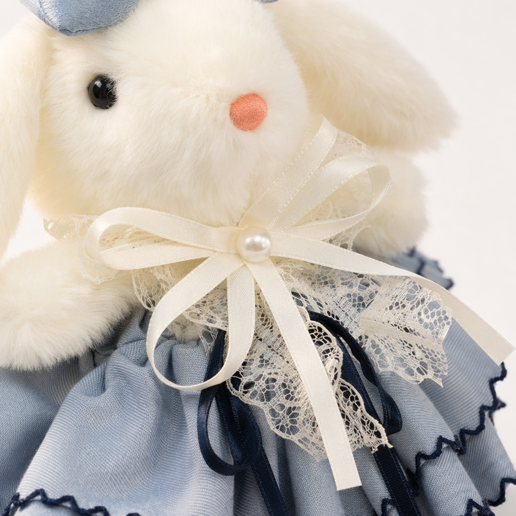 A white plush rabbit doll is wearing a light blue bow on its head and a light blue ruffled skirt decorated with lace and pearls Application Scenario