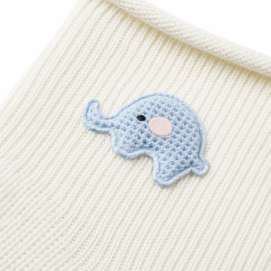 The beige knitted baby socks have a blue embroidered pattern of a little elephant at the top Application Scenario