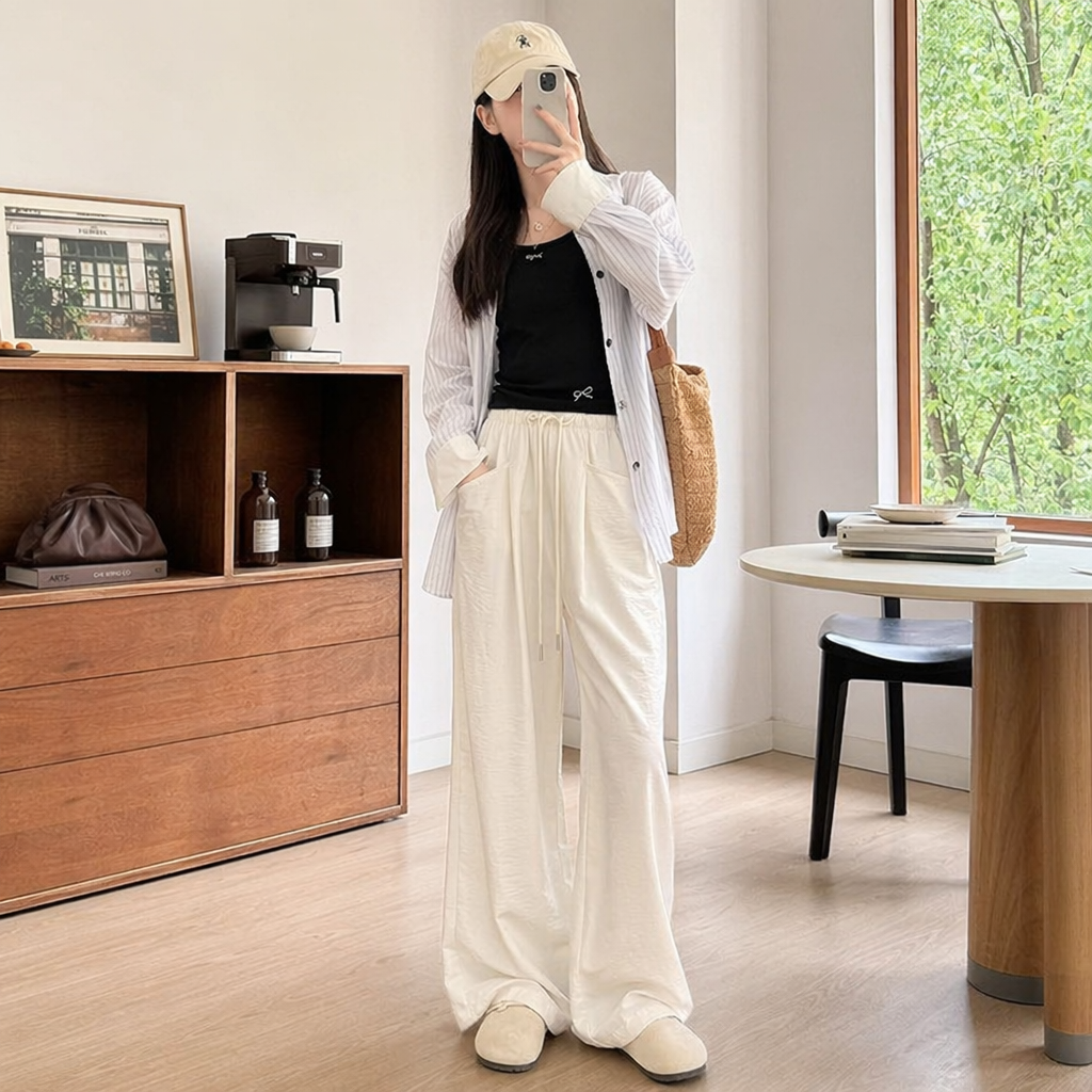 The off-white wide-leg pants of a female model in real photos show a slimming and flowing casual long pants details Picture