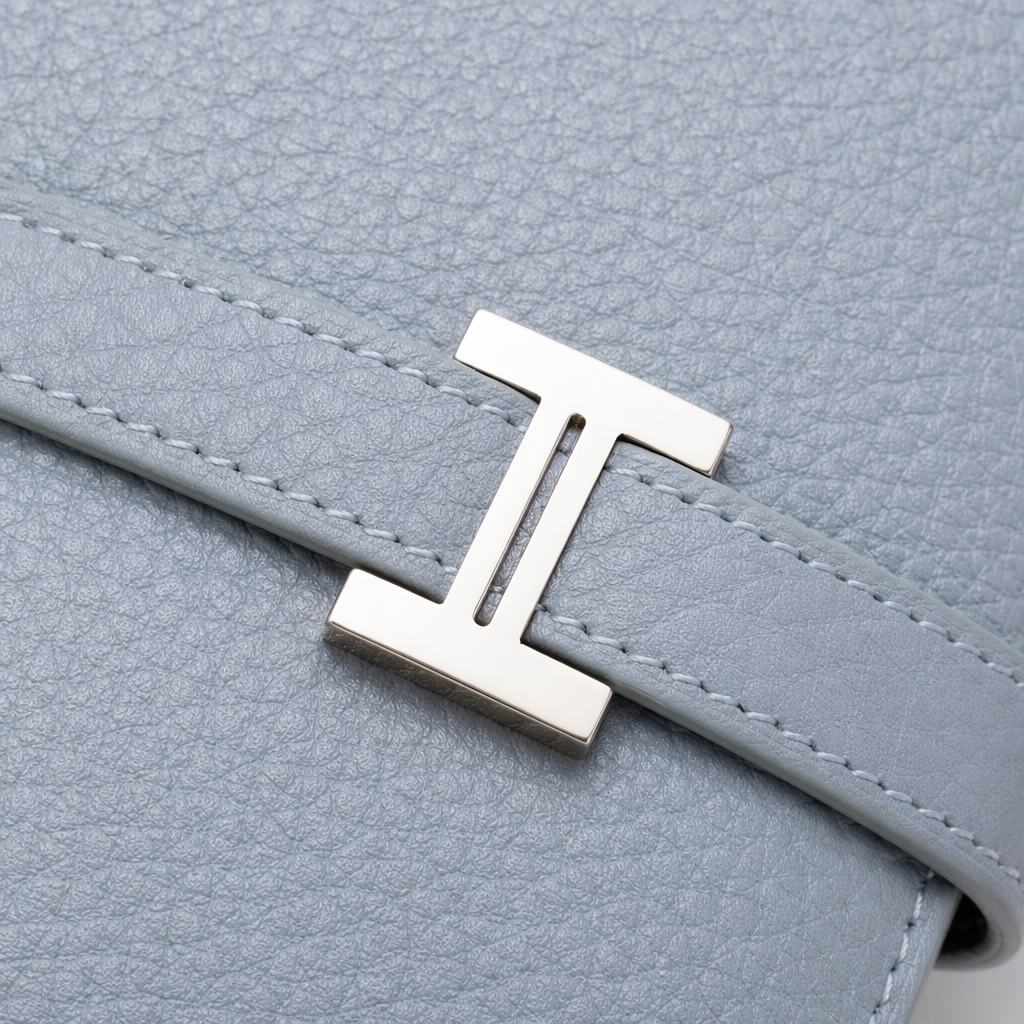 A light grey textured leather wallet with a silver H-shaped metal clasp Application Scenario