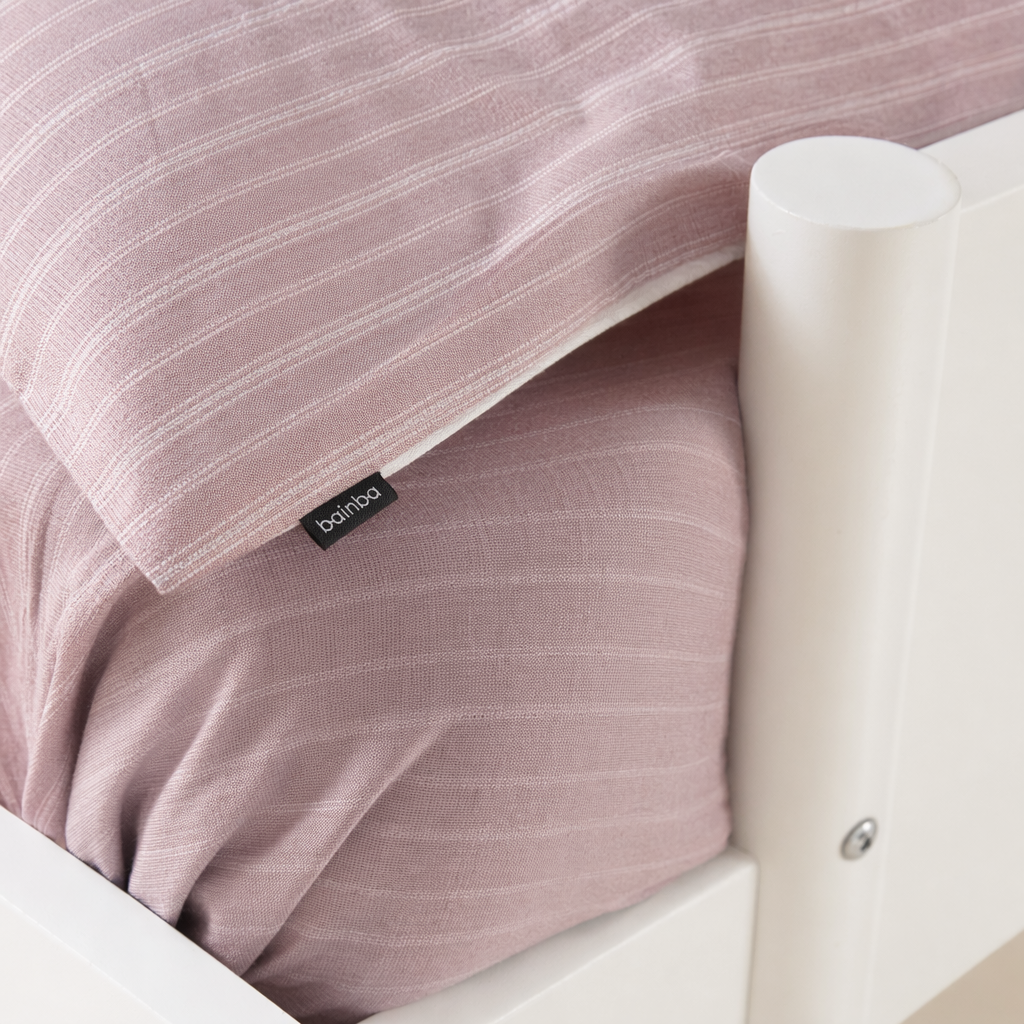 A simple and modern children's bunk bed with a white bunk bed and light green striped bedding set Application Scenario