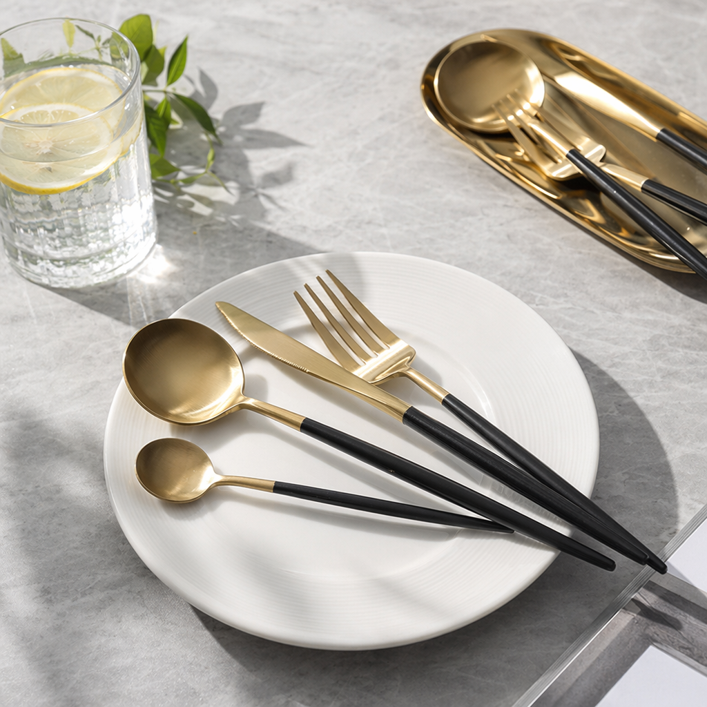 A simple and modern home stainless steel tableware set with gold and black stripes, featuring plates, bowls and chopsticks details Picture