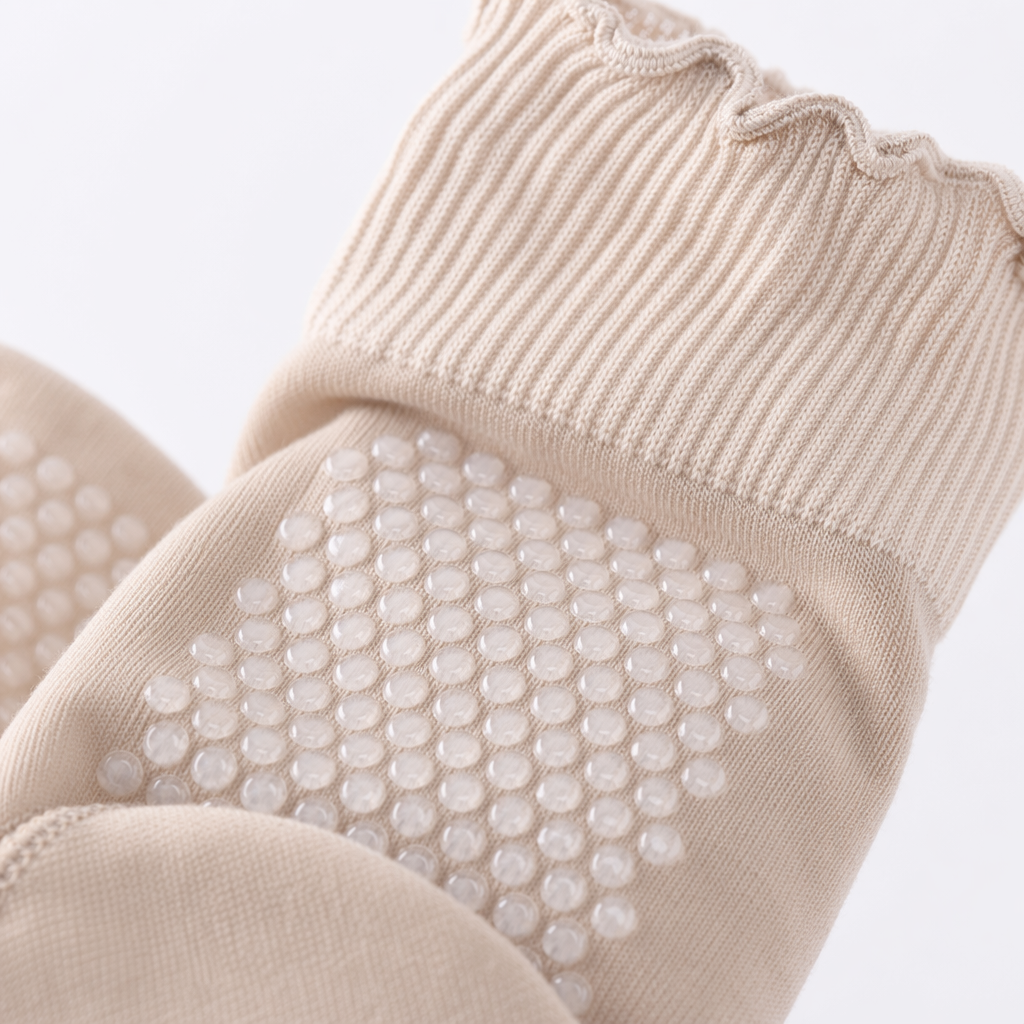 Beige anti-slip socks with white dots on the soles, raised lotus patterns, ribbed cuffs, and full lotus leaf fringes Application Scenario