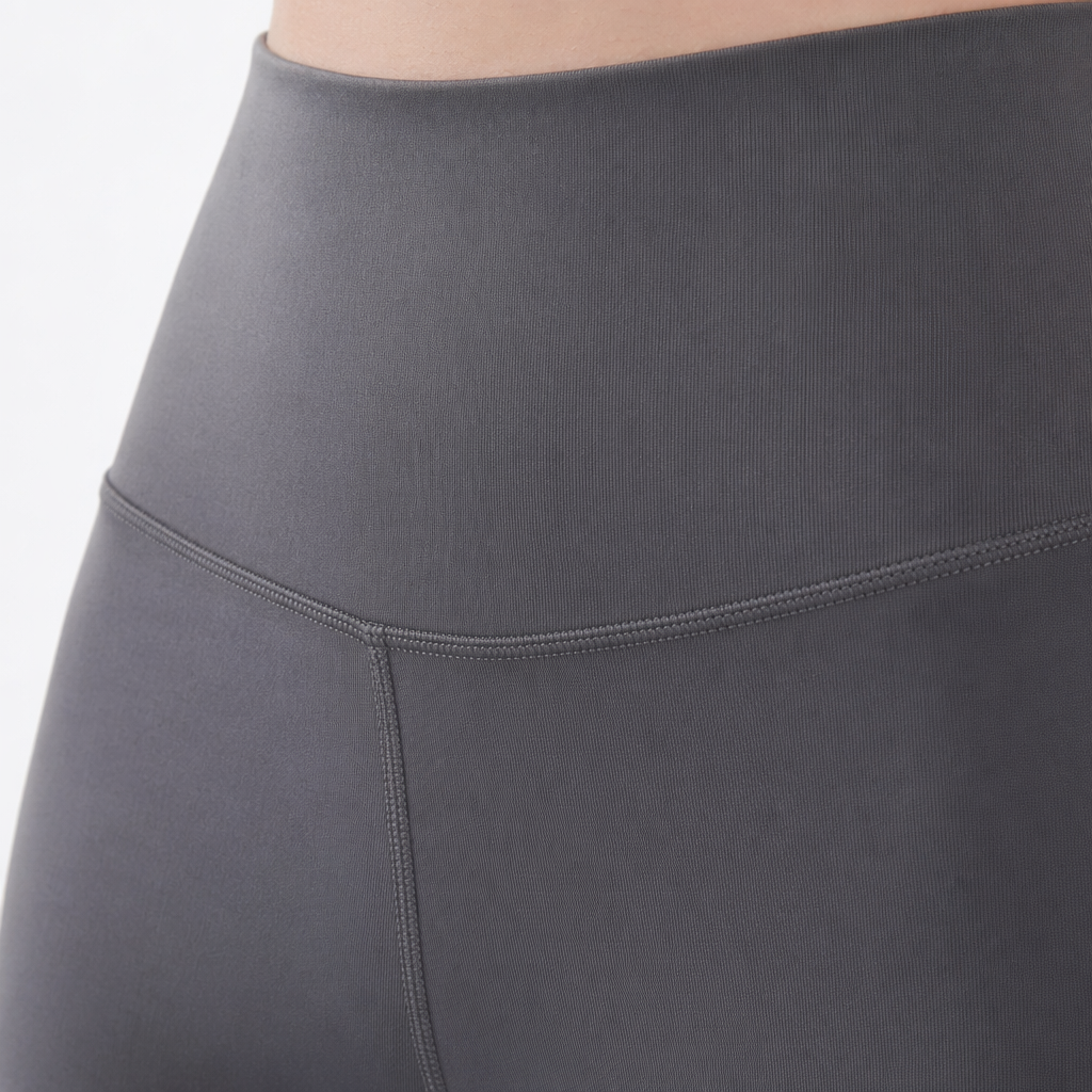 A close-up of the legs of grey high-waisted skinny pants paired with white sports shoes and a small bag Application Scenario