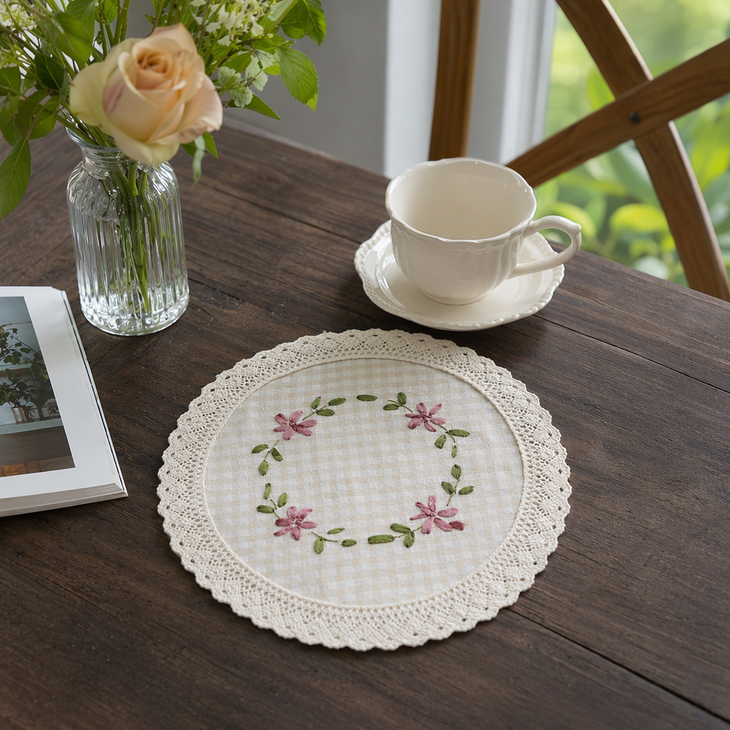 The beige hand-embroidered tablecloth with checkered fabric is embroidered with pink flowers and green branches and leaves details Picture