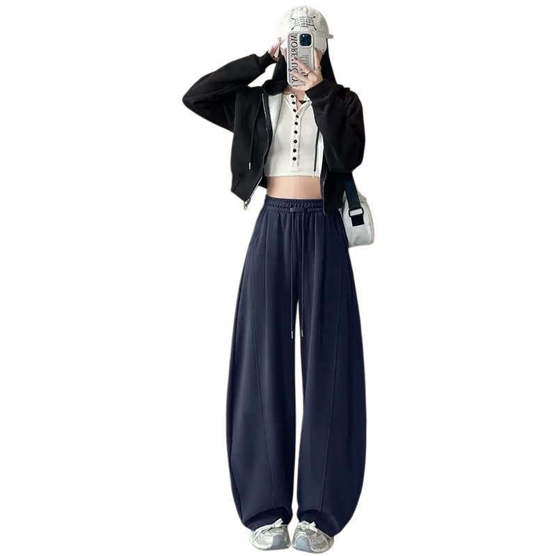 A woman in navy blue wide-leg pants paired with a black hooded jacket and a white short top, the same style as the model Item Picture