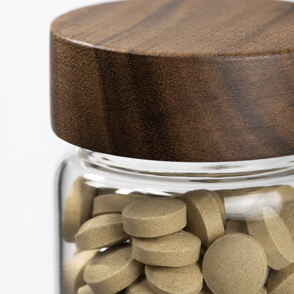 A transparent glass jar with a wooden lid and a light brown tablet storage container Application Scenario