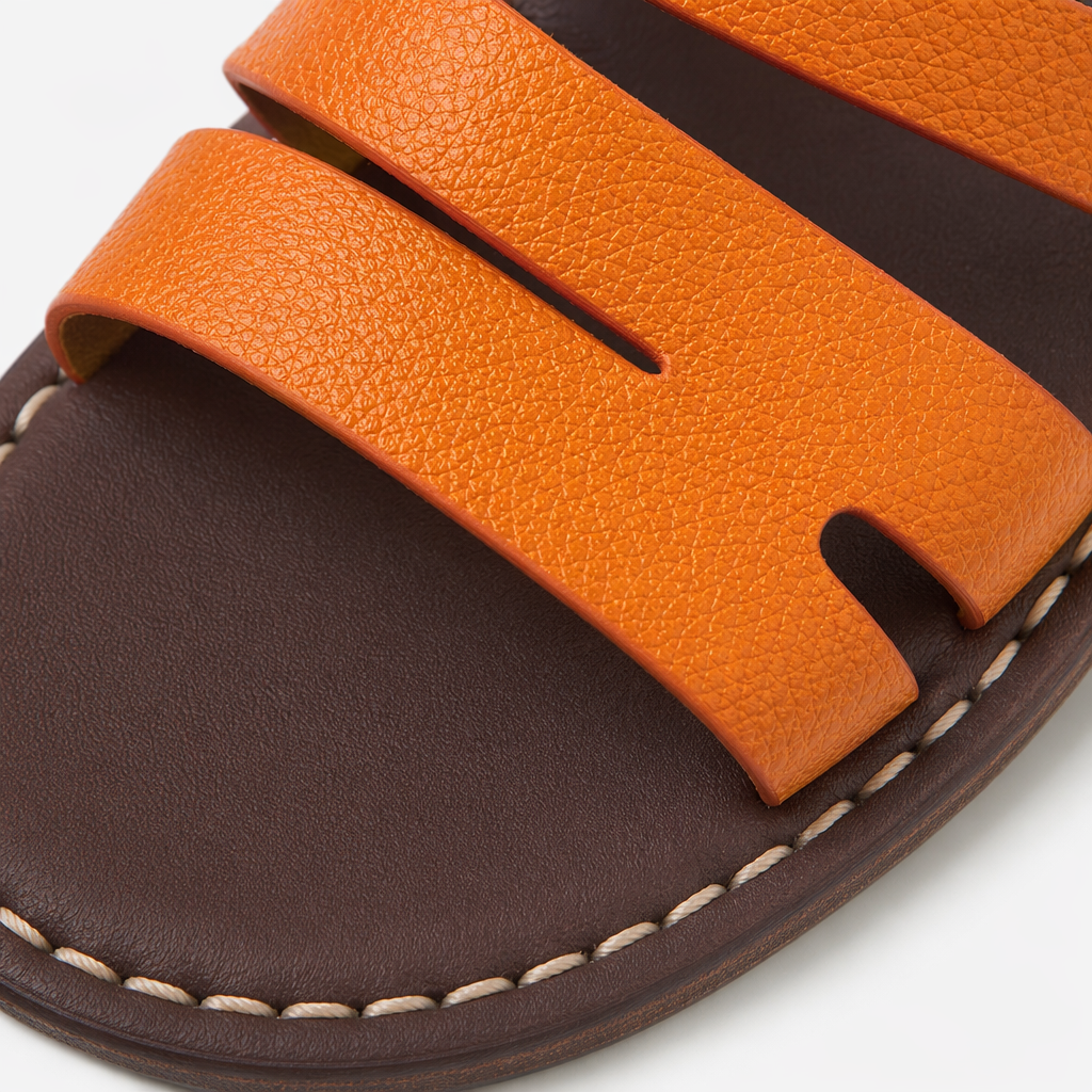Orange and black double-strap sandals with brown soles and white stitching, featuring a single tulip Application Scenario