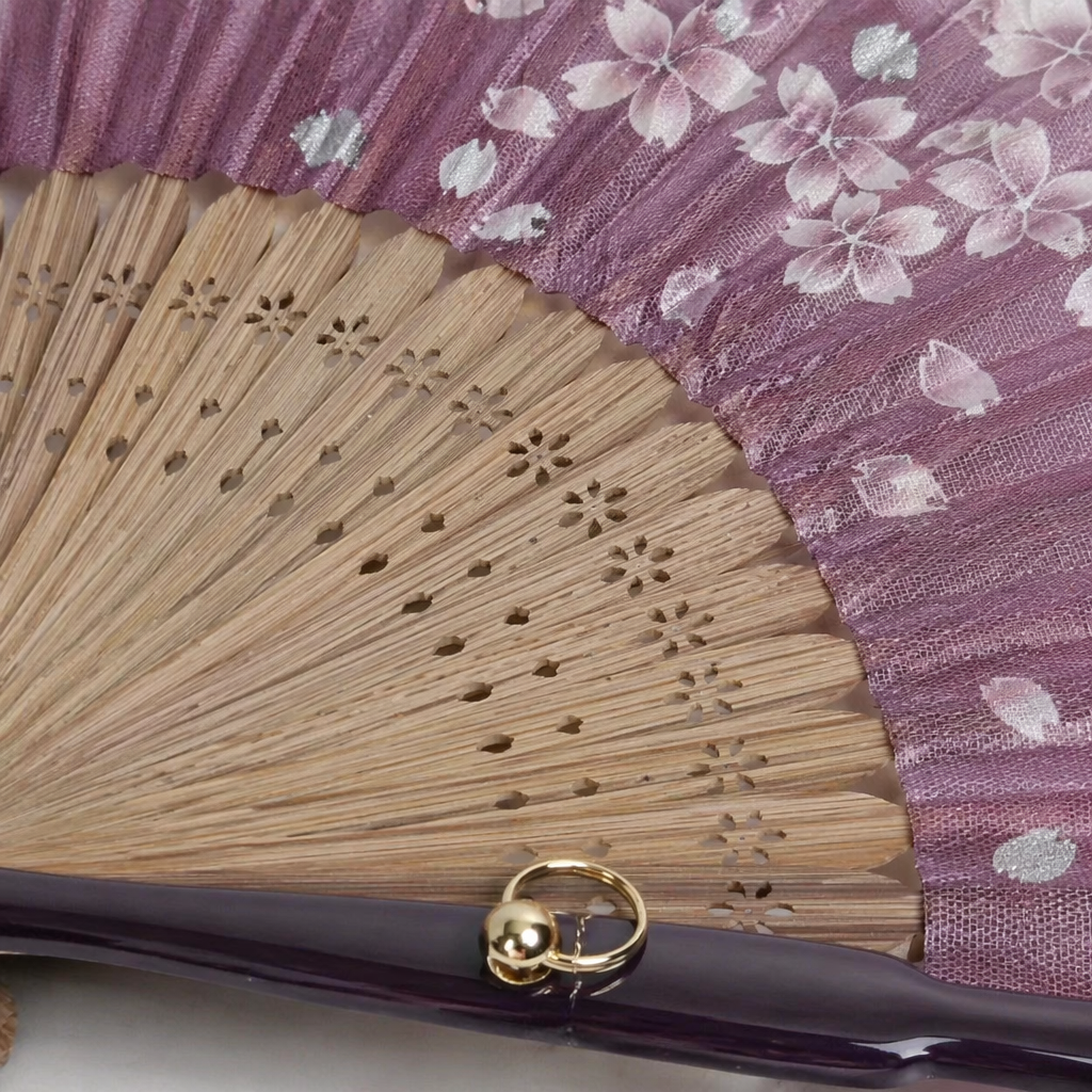 Purple cherry blossom-patterned folding fan, handcrafted bamboo frame folding fan, solid-color background pattern, Japanese-style portable fan Application Scenario