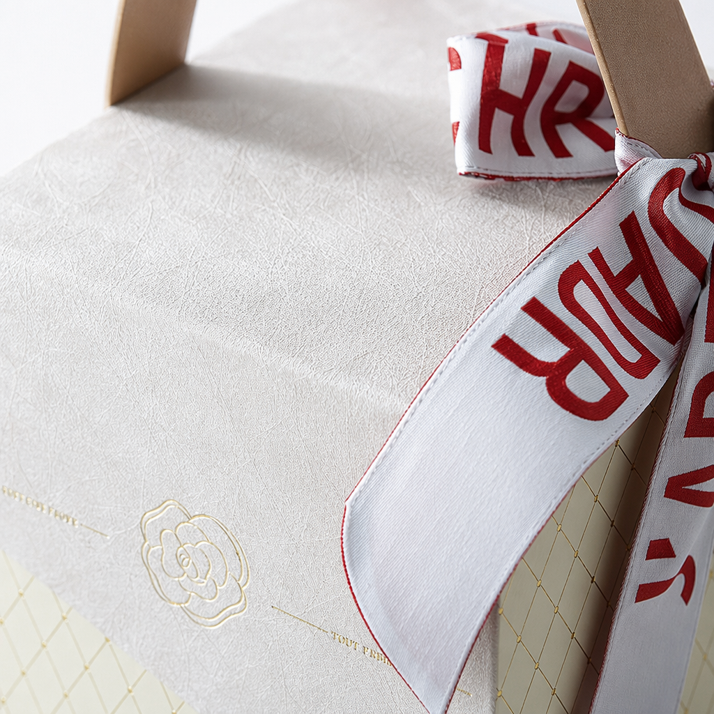 The off-white textured diamond-shaped checkered hand-held gift box is printed with red and white ribbon characters Application Scenario