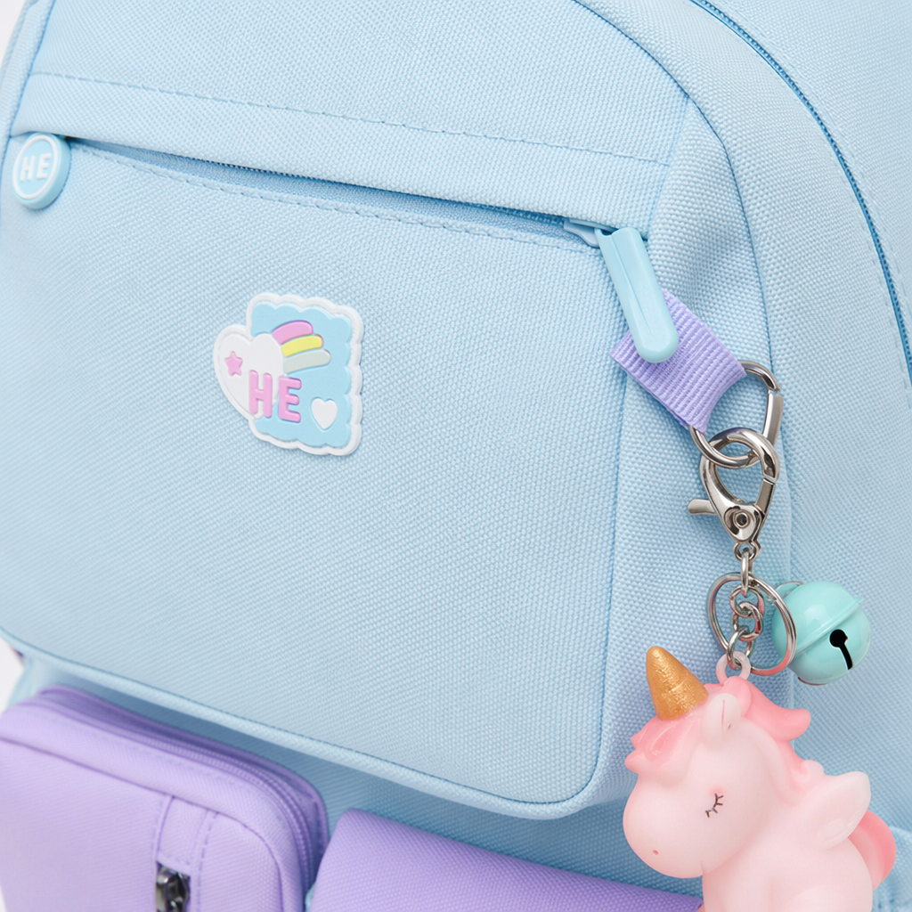 A light blue backpack with a purple front pocket and rainbow decoration, a lightweight student commuting backpack Application Scenario