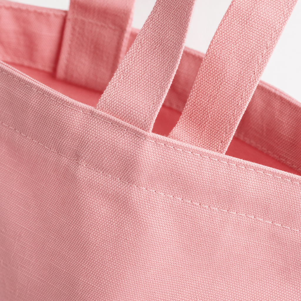 The pink canvas bag is a simple and versatile hand-held shopping bag with an artistic style for daily commuting Application Scenario
