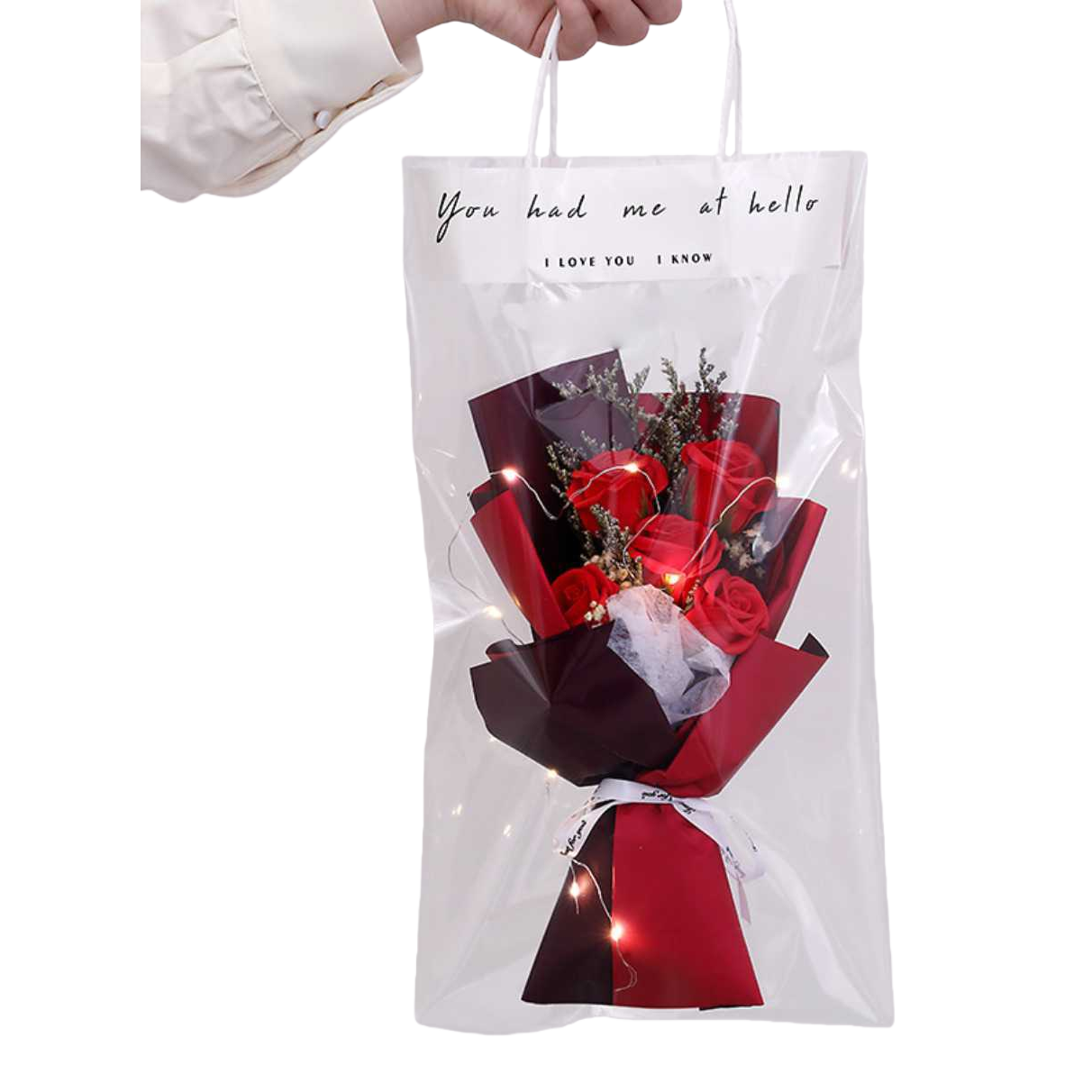 A transparent bagged bouquet of dried red roses with warm light strings, wrapped in red and black paper and white ribbon gift box Item Picture
