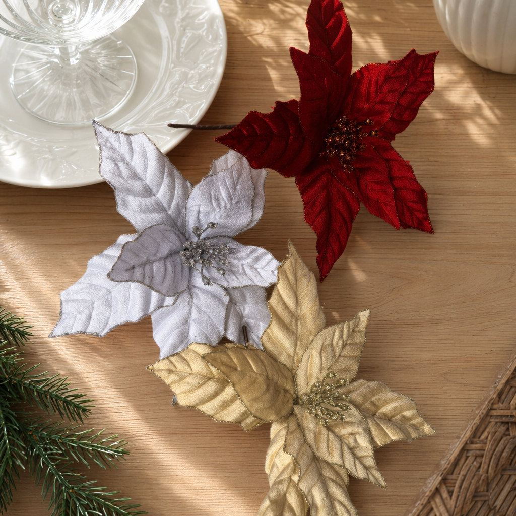 Three artificial poinsettias in red, silver and gold are decorative flowers details Picture