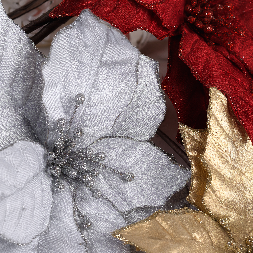 Three artificial poinsettias in red, silver and gold are decorative flowers Application Scenario