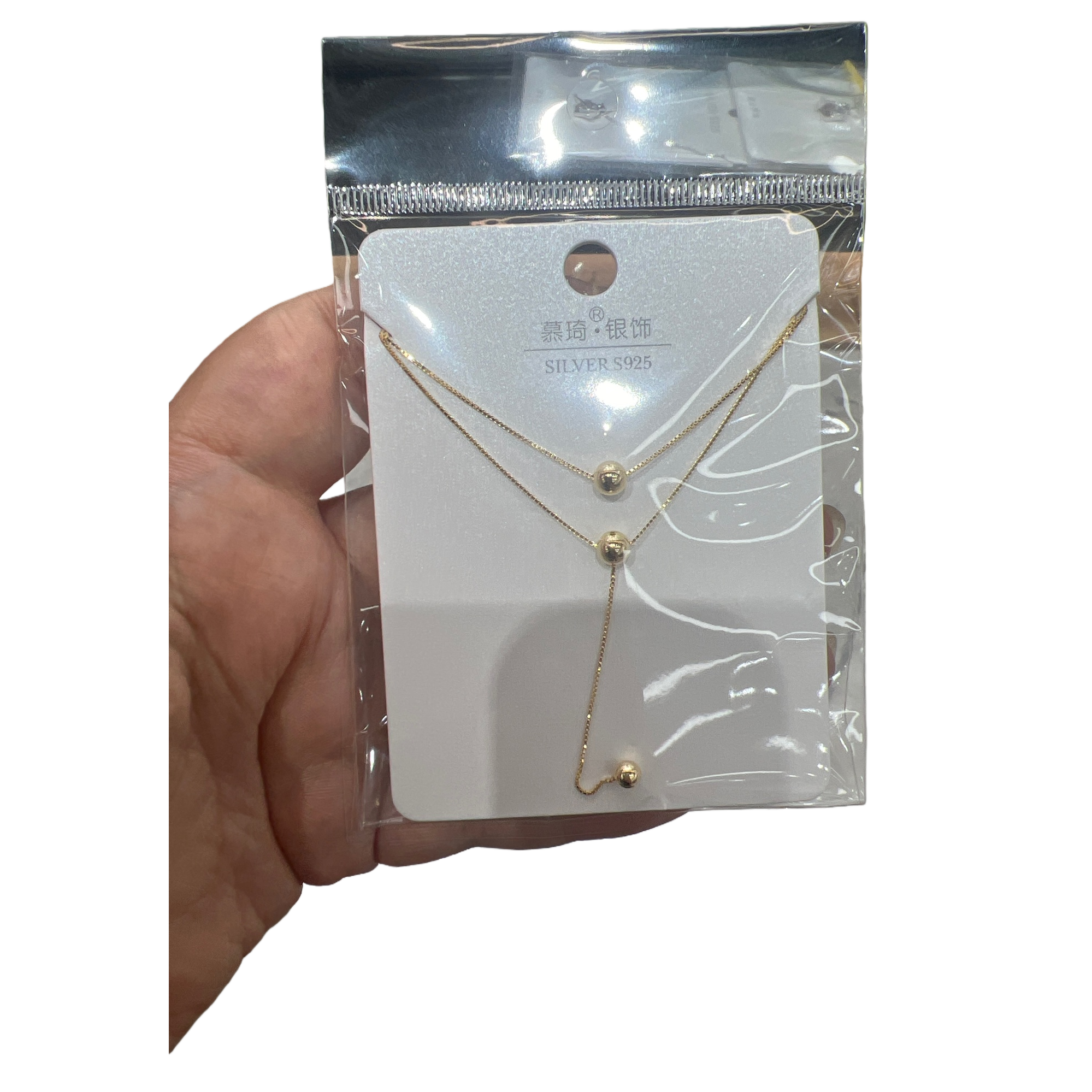 A golden double-layer spherical pendant necklace in a white card transparent bag for handheld display Item Picture