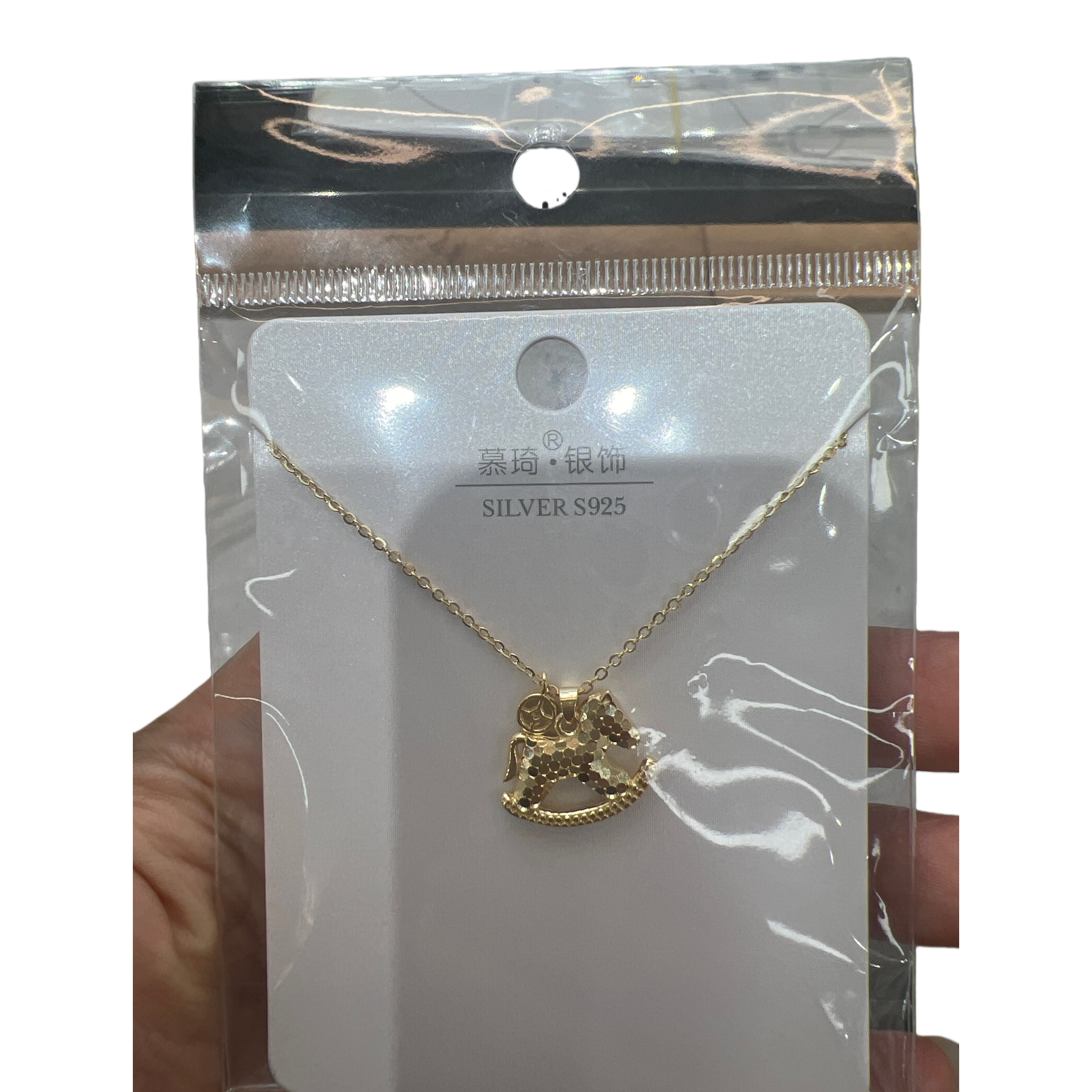 The golden rocking wooden horse pendant necklace is a fashionable, retro and light luxury accessory for girls Item Picture