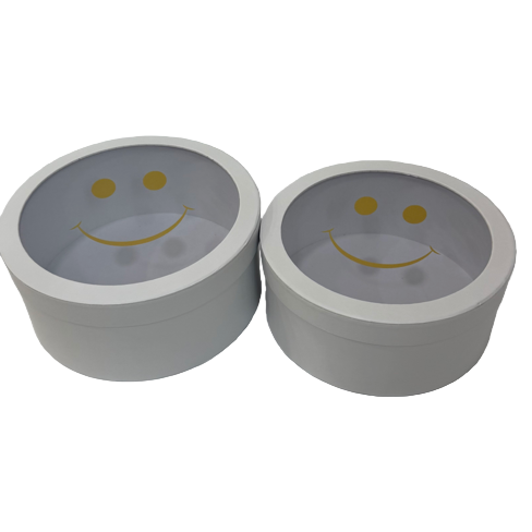A white circular gift box with a transparent lid and a golden smiling face pattern Item Picture