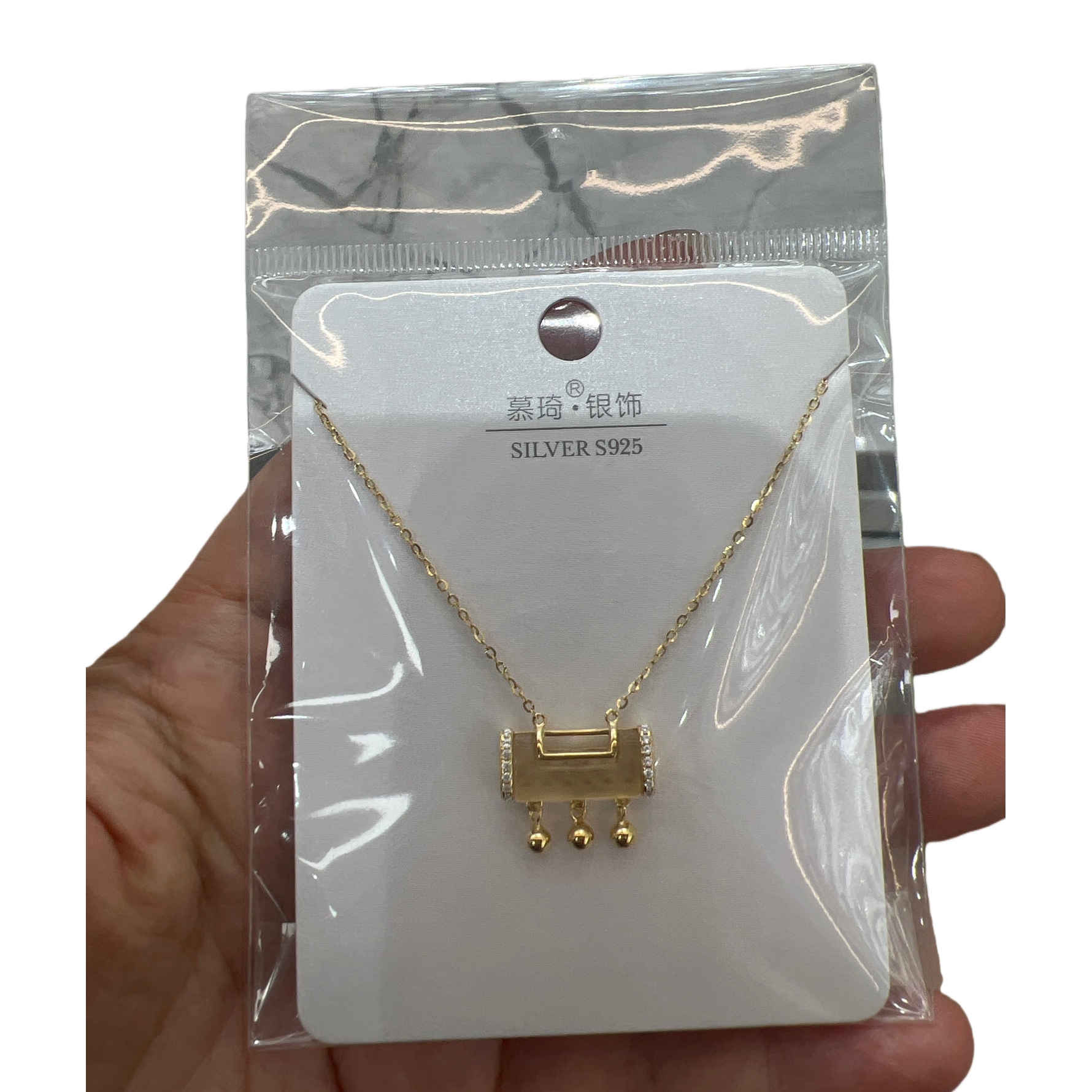 A golden rectangular small bell pendant necklace, held in a transparent bag with a white card Item Picture