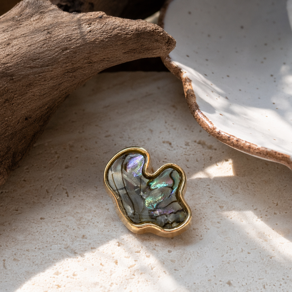 A delicate palm-sized ornament with a golden frame and shell inlaid pendant details Picture