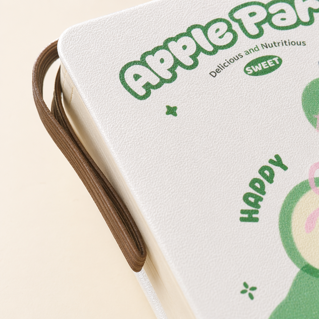 The cover of the white notebook is printed with a green Apple pattern and the words "Apple Party" Application Scenario