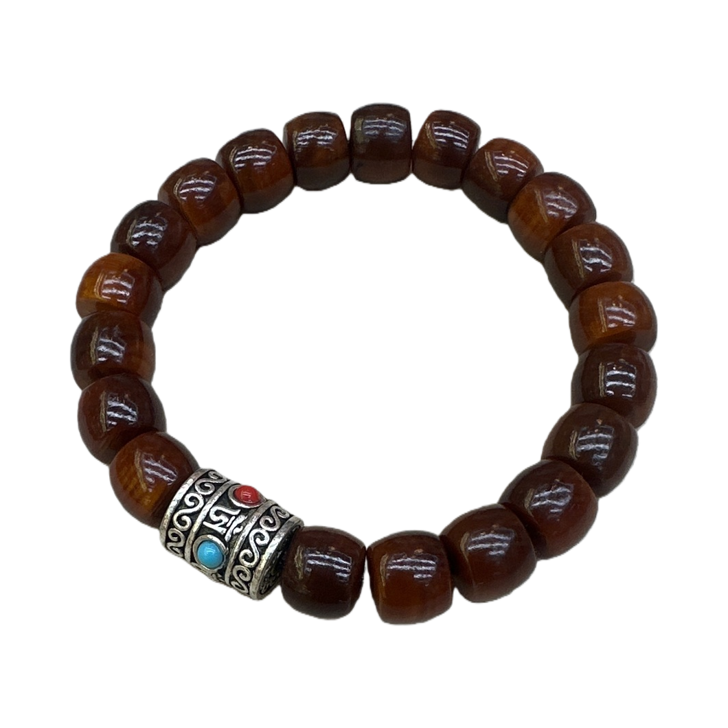 The central silver ornament of the brown beaded bracelet is set with a blue ruby Item Picture