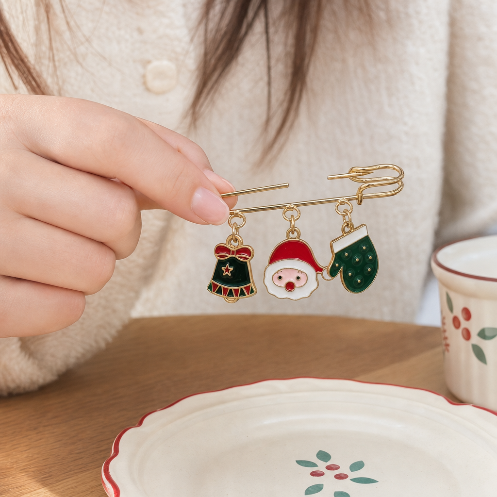 Three pendants with golden Christmas-themed brooches, bells and Santa Claus gloves details Picture