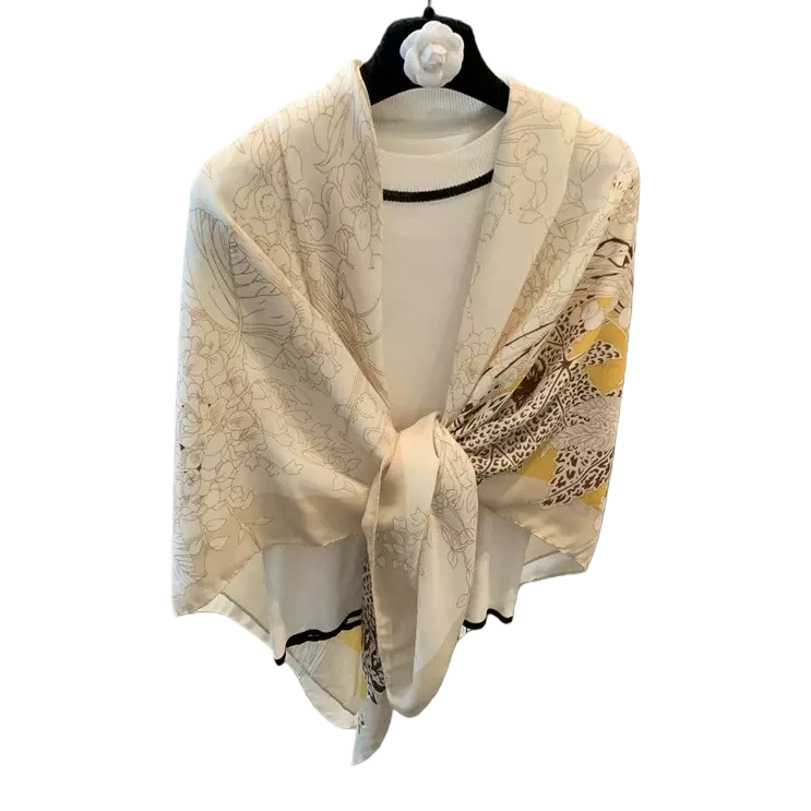 A beige floral pattern scarf paired with a white high-neck sweater as a warm autumn and winter accessory Item Picture