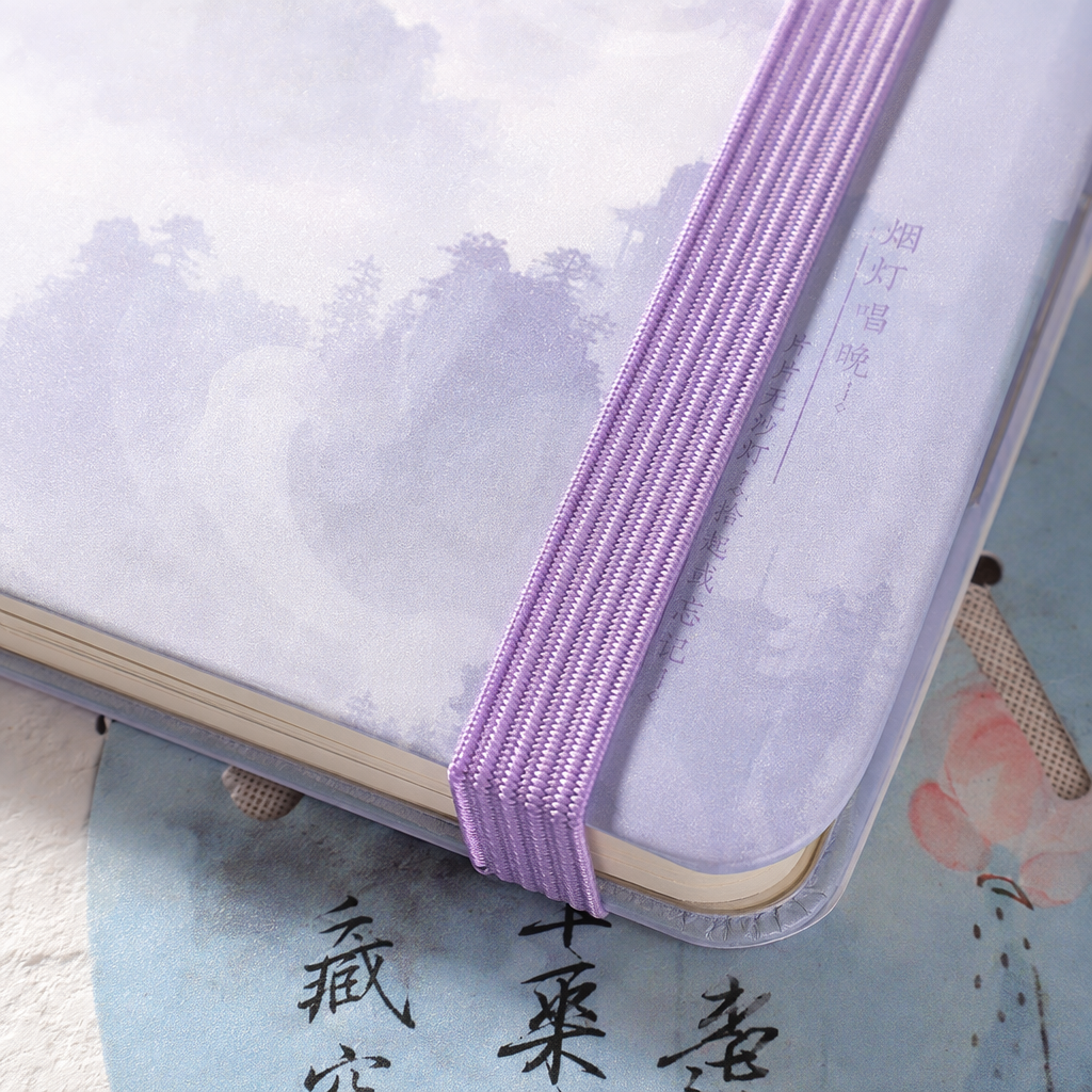 The light purple strap-tied notebook features an ink-wash landscape painting cover with a calligraphy background Application Scenario