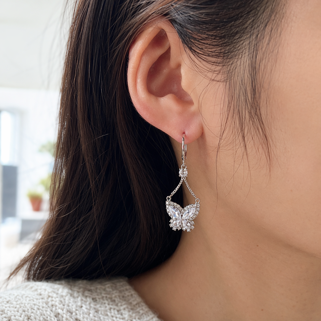 ANEIRA golden butterfly earrings set with transparent crystal suspension chains and 925 silver needles details Picture