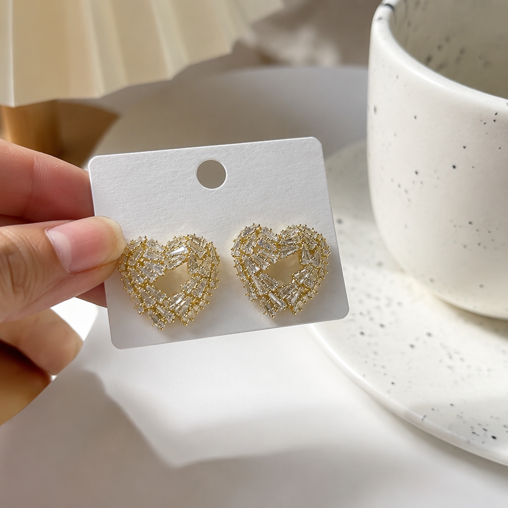 Golden heart-shaped diamond-encrusted stud earrings in white card packaging, fashionable and light luxury earrings details Picture