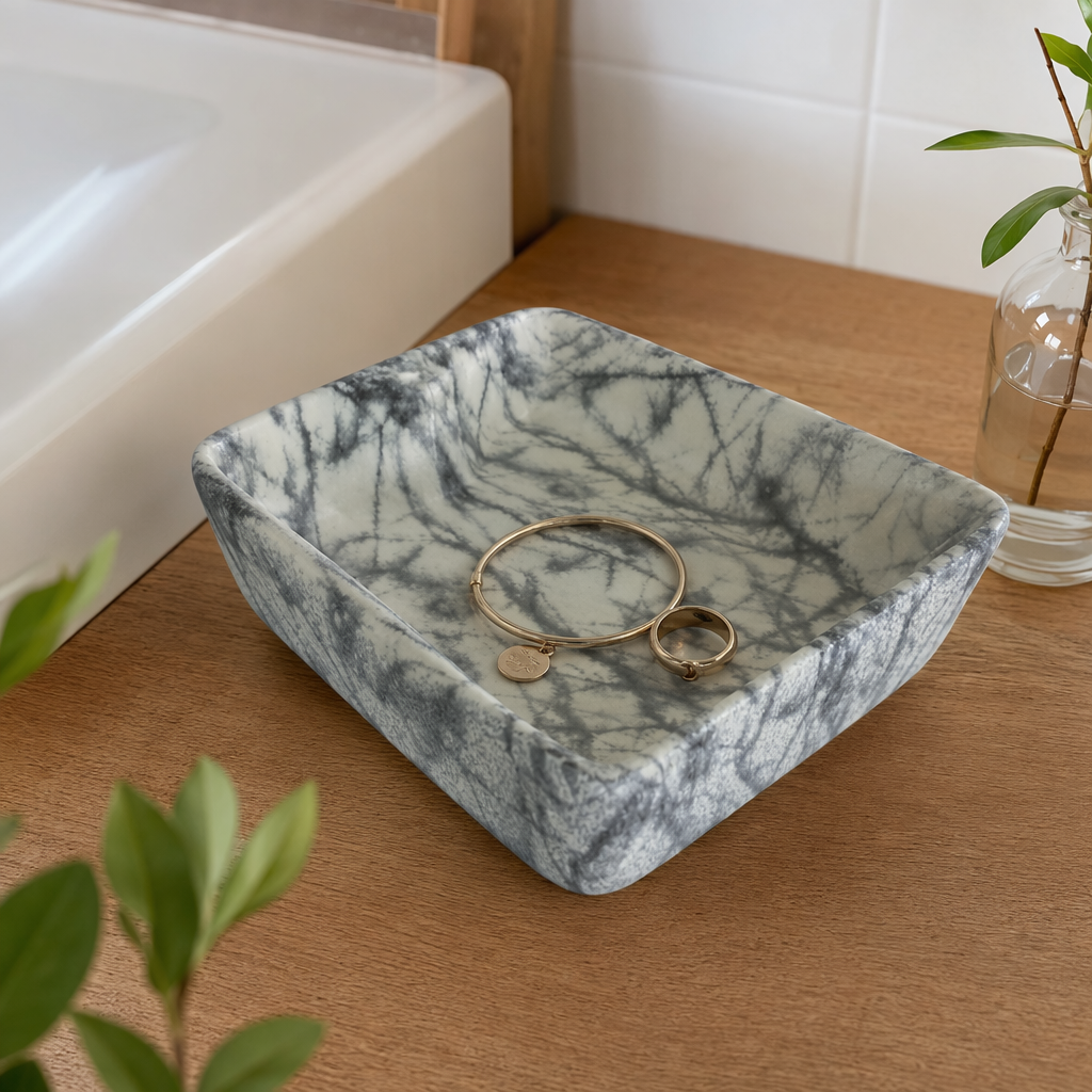 A modern and simple bathroom basin with grey and white marble-textured ceramic washbasin under the basin details Picture