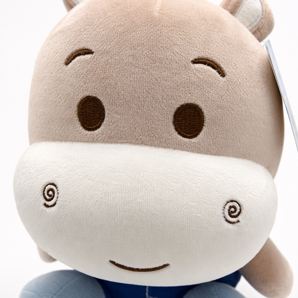 The pink and white patchwork plush toy has a blue label on the head Application Scenario