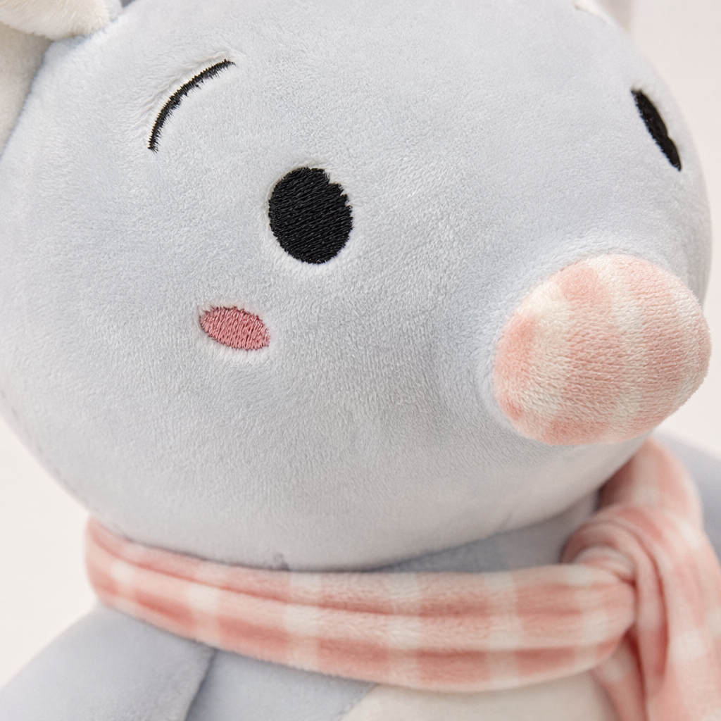 A light blue plush toy wearing a pink and white checkered scarf with the word "Love" printed on its belly Application Scenario
