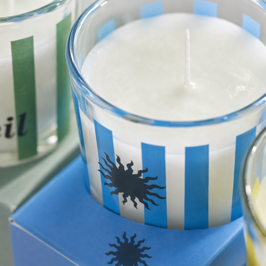 Club Soleil Three striped glass cup scented candles with green, white, blue, white, yellow and white sun patterns Application Scenario