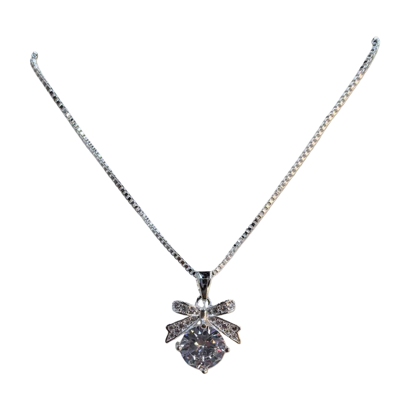 A silver alloy bow rhinestone pendant necklace hangs with round-cut crystals Item Picture