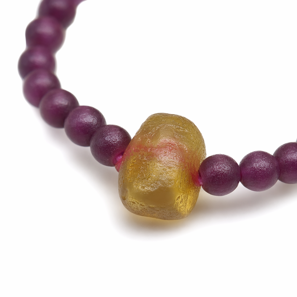 The purple-red beaded bracelet is decorated with yellow irregular gemstones in the center Application Scenario