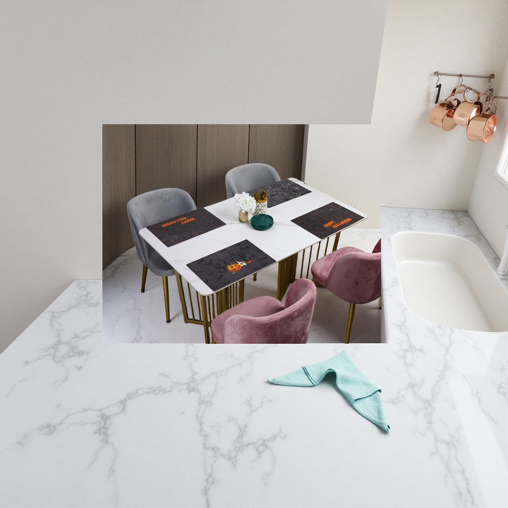 A white marble dining table with grey and pink suede chairs and Halloween-themed placemats Application Scenario