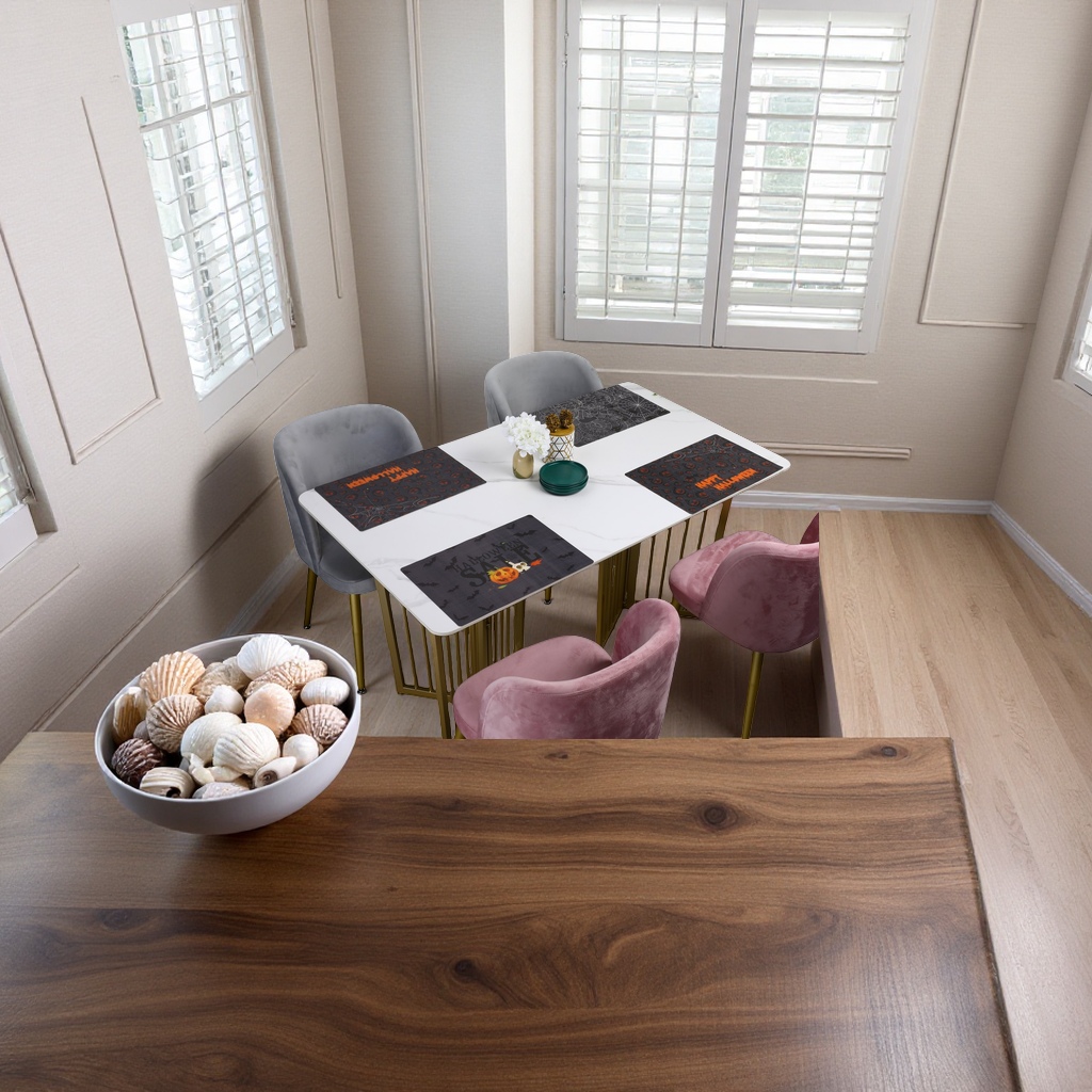 A white marble dining table with grey and pink suede chairs and Halloween-themed placemats Specification image