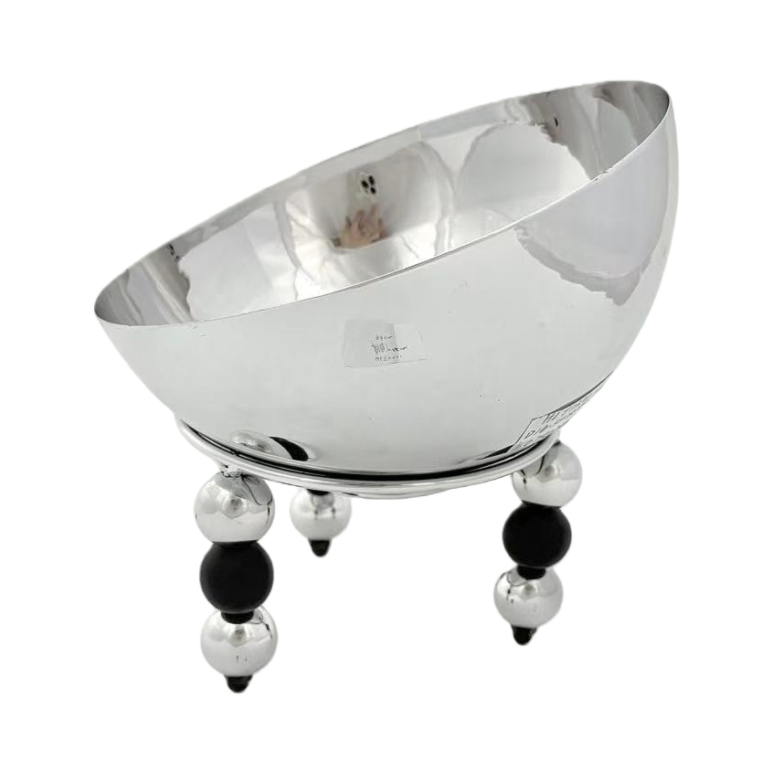 A silver metal bowl-shaped dining bowl with black and silver spherical feet Item Picture
