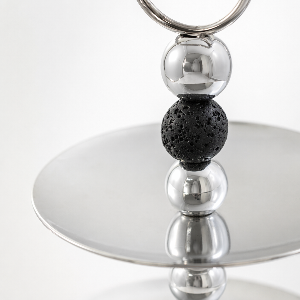 A silver double-layer tray with a circular handle made of black and white beads Application Scenario