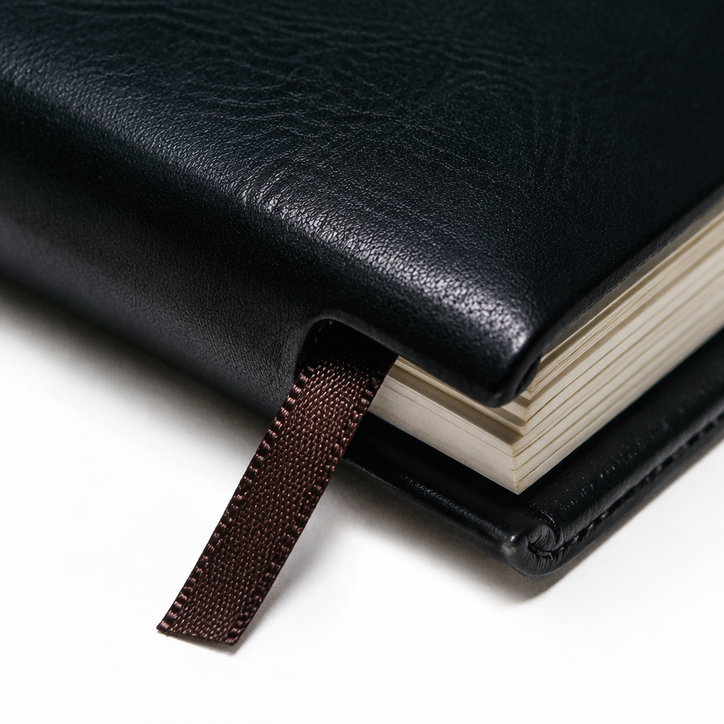 Three black leather INDEX notebooks stacked together with white labels, 80 grams, 148 sheets Application Scenario