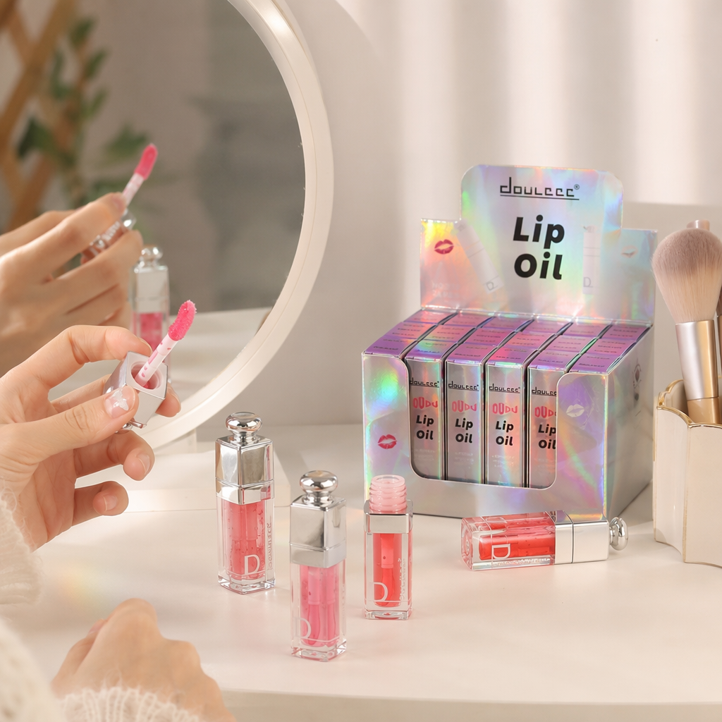 Pink background, shiny gradient lip oil set, transparent bottle, silver cap, colorful gift box details Picture