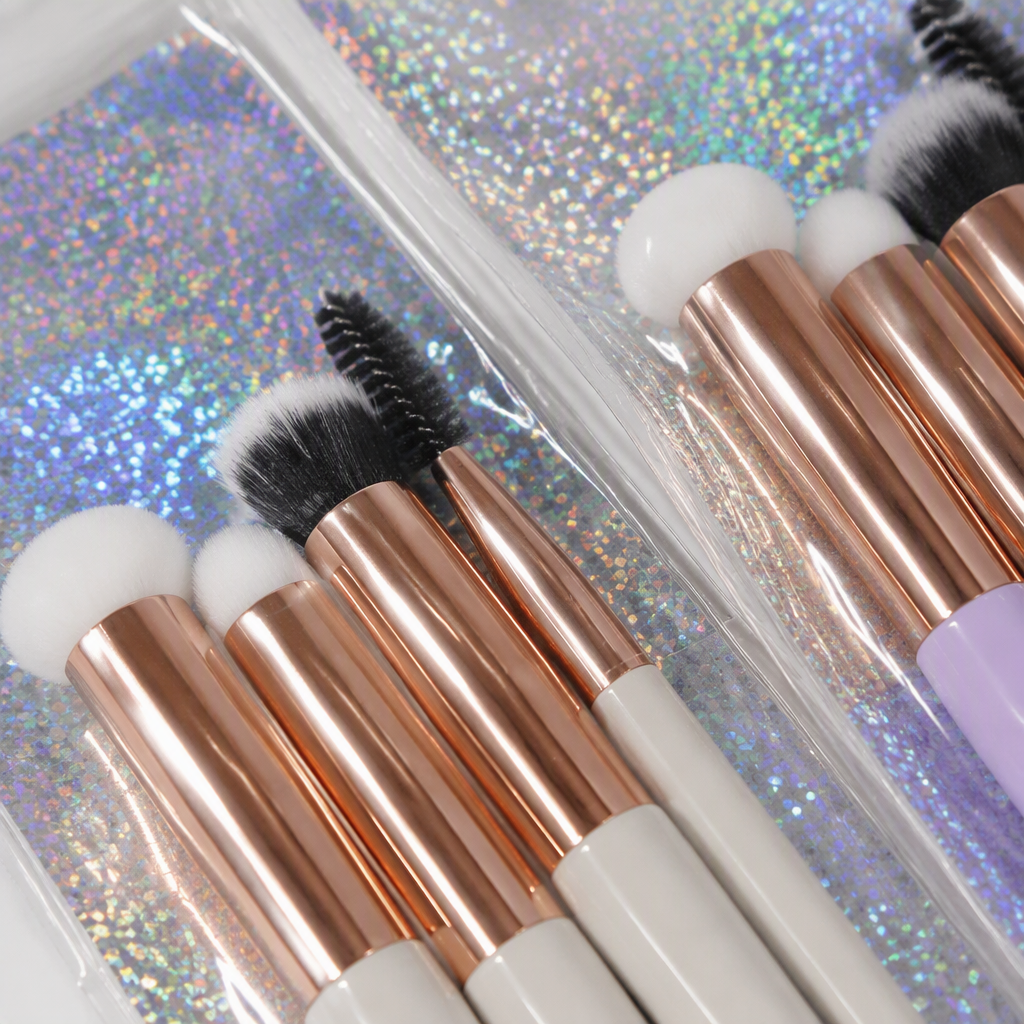A set of makeup brushes with multiple rose gold handles in a colorful glitter packaging, a long-lasting beauty tool that won't smudge Application Scenario