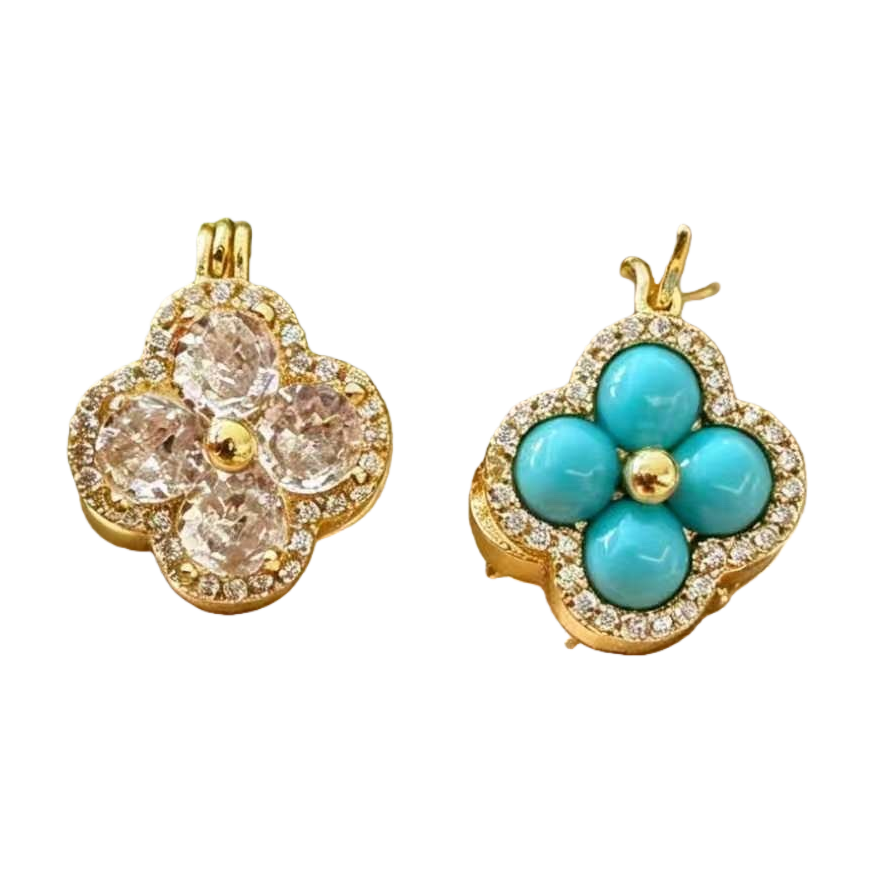 A golden four-leaf flower-shaped pendant set with crystal and turquoise, surrounded by small diamonds, with a green leaf background and an elegant beige base Item Picture