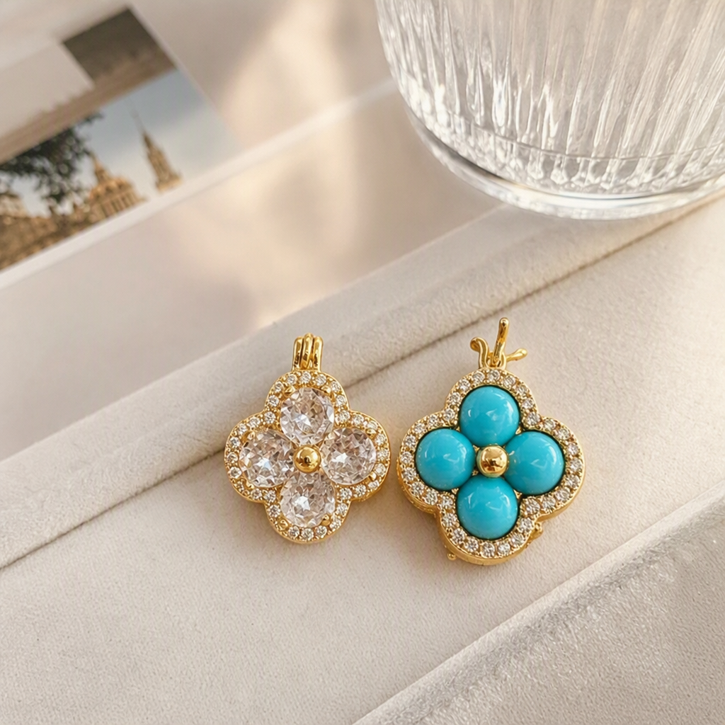 A golden four-leaf flower-shaped pendant set with crystal and turquoise, surrounded by small diamonds, with a green leaf background and an elegant beige base details Picture